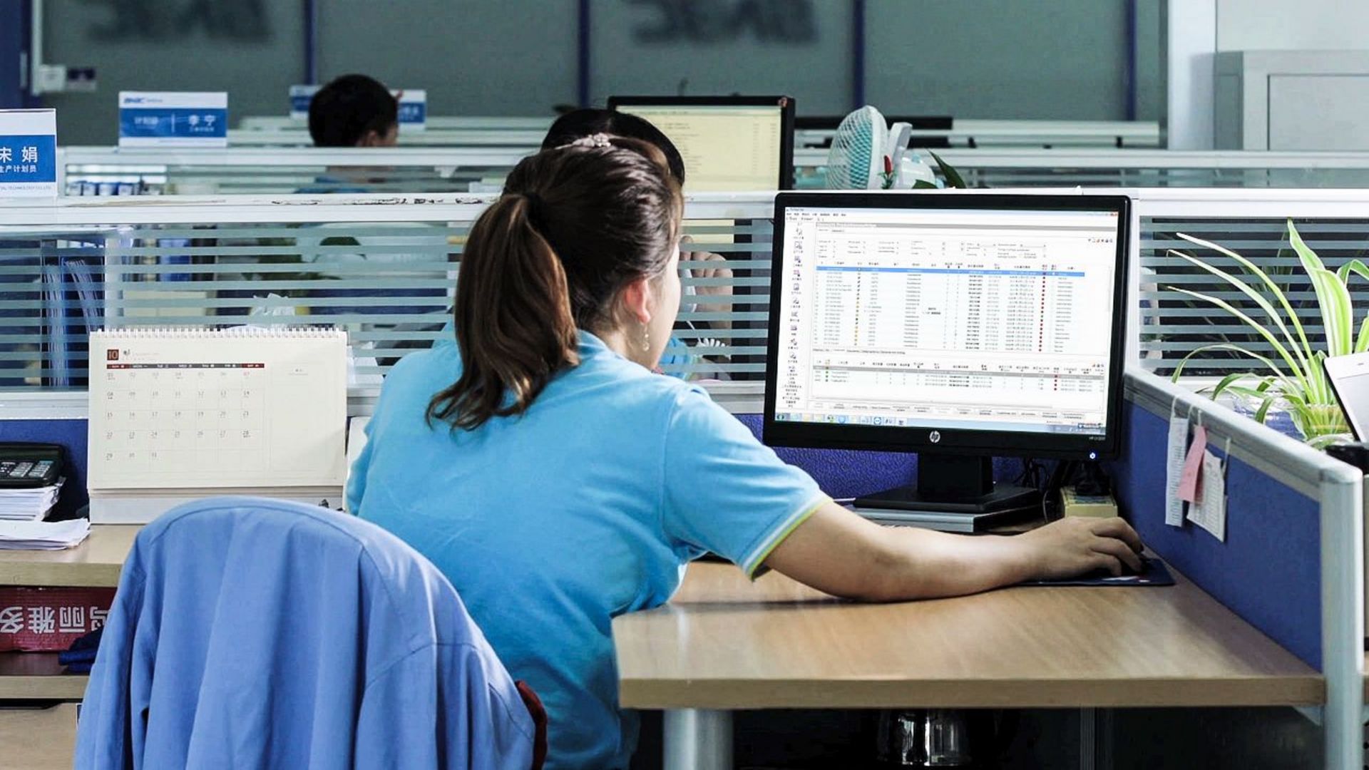 Personnel sitting before a monitor